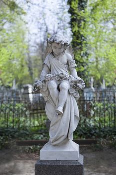 Angel and cross monument on a very old grave.