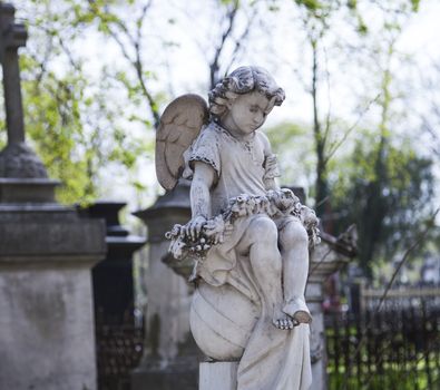 Angel and cross monument on a very old grave.