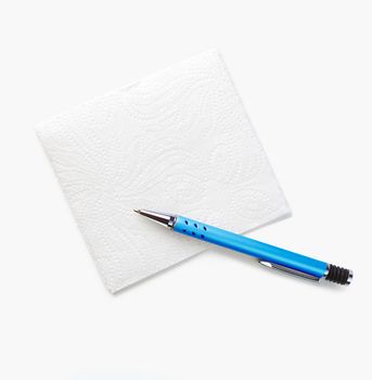 White napkin and pen for notes isolated on a white background. The view from the top.