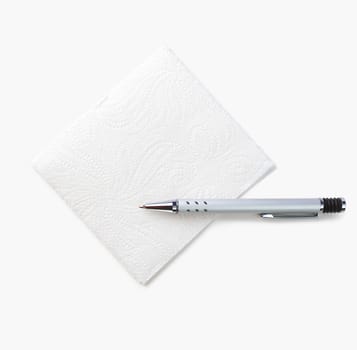 White napkin and pen for notes isolated on a white background. The view from the top.
