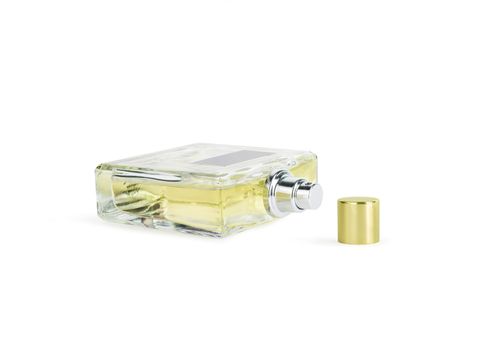 Perfume in beautiful yelow color bottle isolated on white background