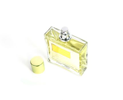 Perfume in beautiful yelow color bottle isolated on white background
