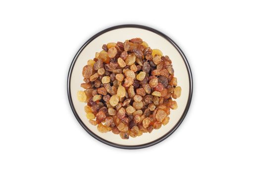 Raisins in a clear glass dish top view close up isolated