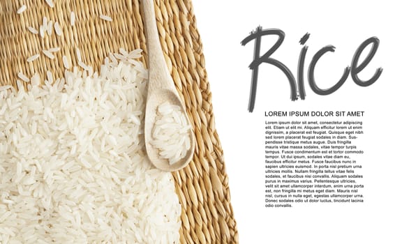 Asian uncooked white rice in a wooden spoon on a background of straw.