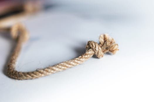 Rope with knot isolated over white background. Bluren concept
