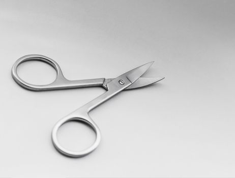 Small steel nail scissors on white background