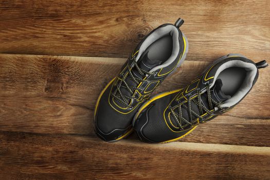 Sport shoes on wooden background. Fitness concept