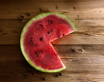 Watermelon slice on the isolated wooden background. With clipping path