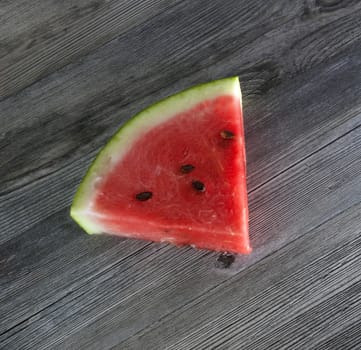 Watermelon slices on the isolated wooden table
