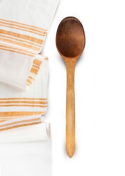 Wooden spoons and homespun towel isolated on white background