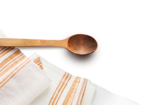 Wooden spoons and homespun towel isolated on white background
