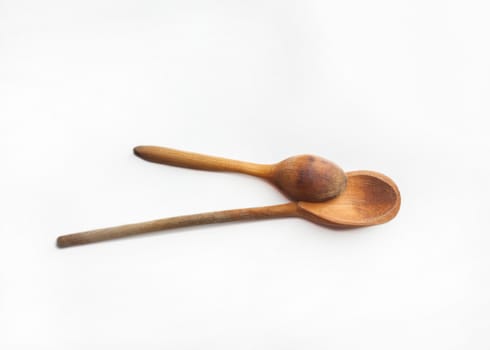 Two old wooden spoons isolated on white background
