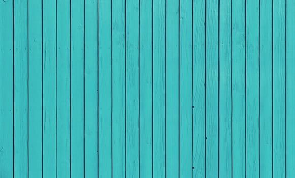Wooden slat fence with parallel planks with blue paint.
