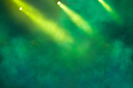 Stage light projector and yellow glitter lights on green background. Abstract Spotlight Glitter lights background.