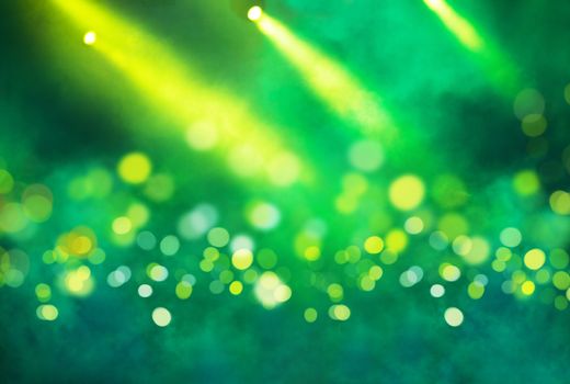 Stage light projector and yellow glitter lights on green background. Abstract Spotlight Glitter lights background.