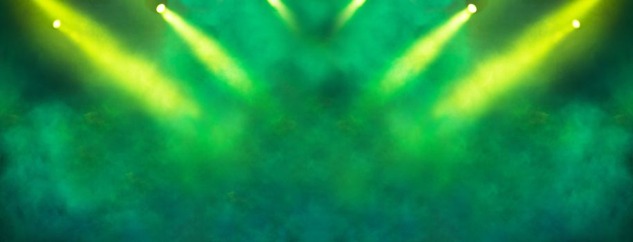 Stage light projector and yellow glitter lights on green background. Abstract Spotlight Glitter lights background.