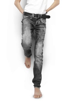 Teenager in black jeans and a white t-shirt barefoot isolated. With clipping path