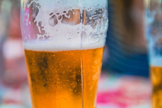 Closeup on a beer glasses at a restaurant.