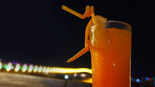 Exotic summer drinks, against blur night city view background