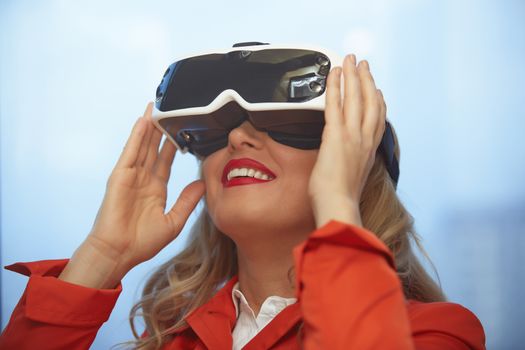 Woman in red coard using VR glasses headset