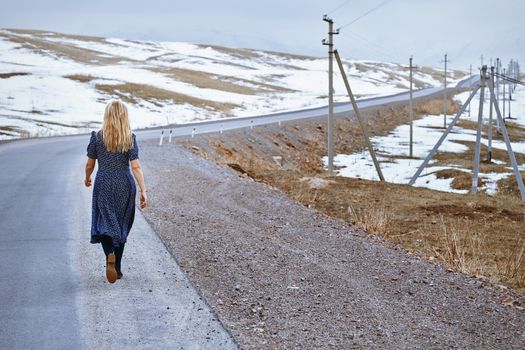 Woman walking along the rural highway