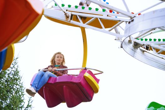 Scared or boring woman riding on rollercoaster