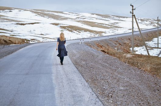 Woman walking along the rural highway