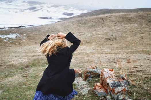 Woman running away in the winter landscape