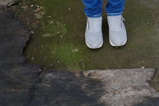 Woman standing on the moss at the old wood trunk