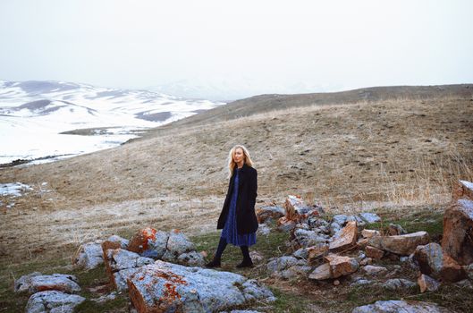 Serious woman walking in the winter landscape