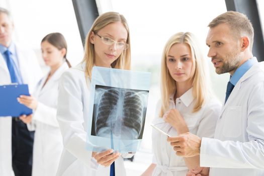 Clinic, people, healthcare and medicine concept - group of medics with chest x-ray scan at hospital