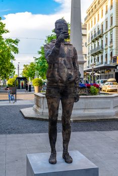 Modern sculpture monument of man with mobile phone in Geneva, Switzerland.