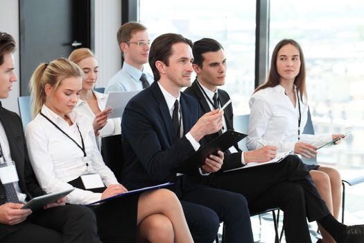 Audience of business people at conference or seminar
