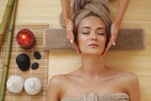 Beautiful young woman relaxing in spa salon