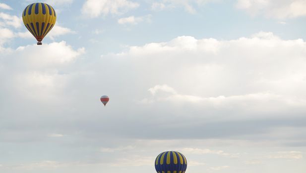 Three hot air balloons flying in the sky