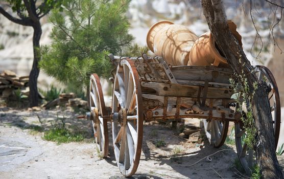 Ancient wooden wheeled wagon with pots