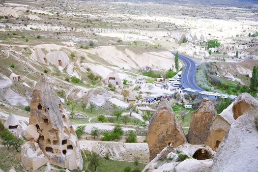 Travel bus station with crowd of people in rocky valley of Cappadocia, Turkey