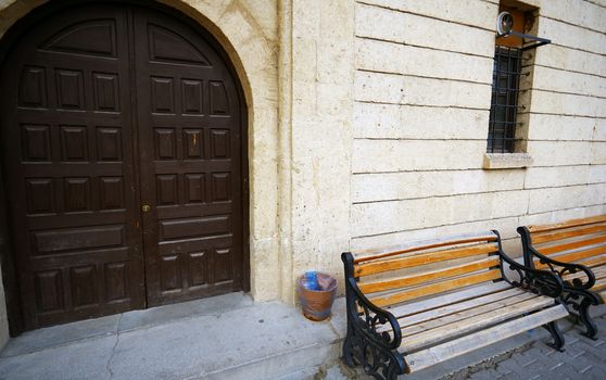 Empty bench at the stony house in old town. High angle view