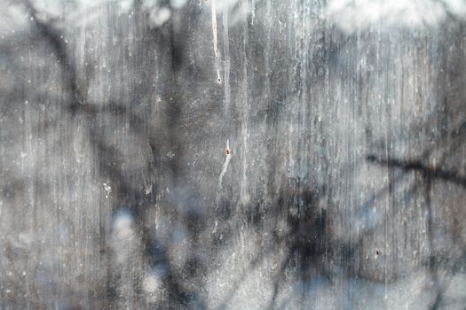 Textured background of the dirty window glass. Close-up