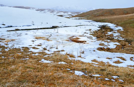 Snowy steppe at the mountains