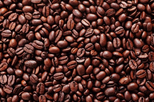 Sea of rich brown roasted coffee beans as an abstract background texture