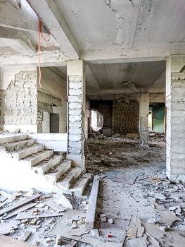 The ruins of a large destroyed building, pieces of stone, concrete, clay and metal