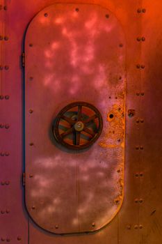 closed rusty submarine door with a valve, old vintage interior, underwater transportation