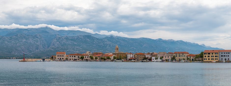 Traditional old village Vinjerac, Croatia, Velebit mountains and Paklenica national park in background, dramatic sky clouds, panorama