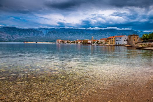 Traditional old village Vinjerac, Croatia, Velebit mountains and Paklenica national park in background, dramatic sky clouds, beach in forground, copyspace