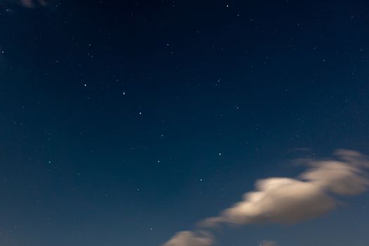 Ursa Major constellation in night sky with clouds, copyspace, astrophotography, blue sky