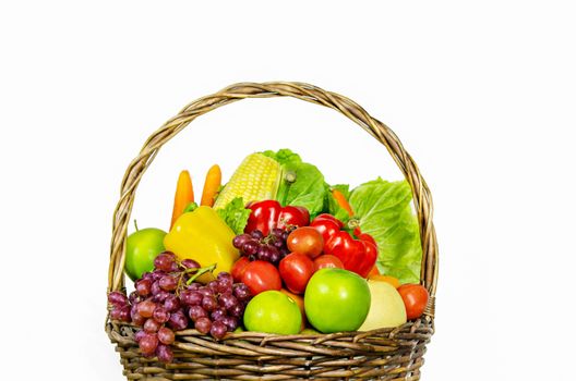 fresh vegetables and fruits in wicker basket over white background