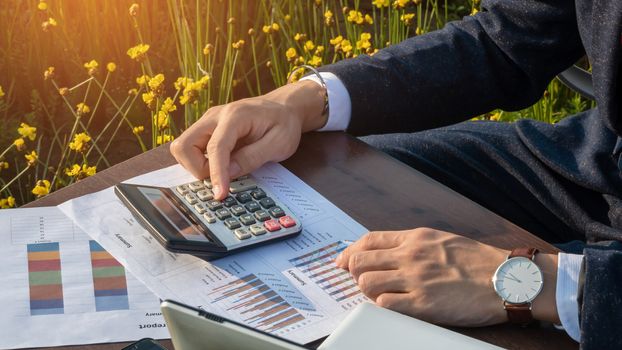 Asian businessman working with a calculators outdoor