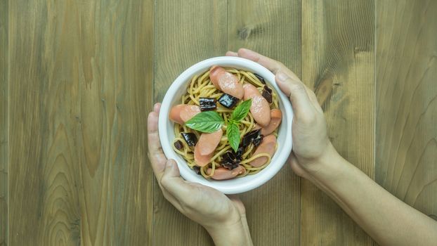 Spaghetti with sausage  and dried peppers , hot and spicy on wooden background, top view