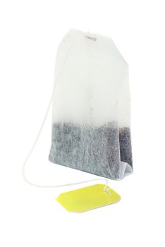 Teabag with yellow label isolated on a white background